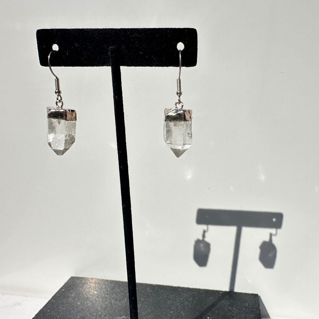 Clear Quartz crystal earring points on a stand