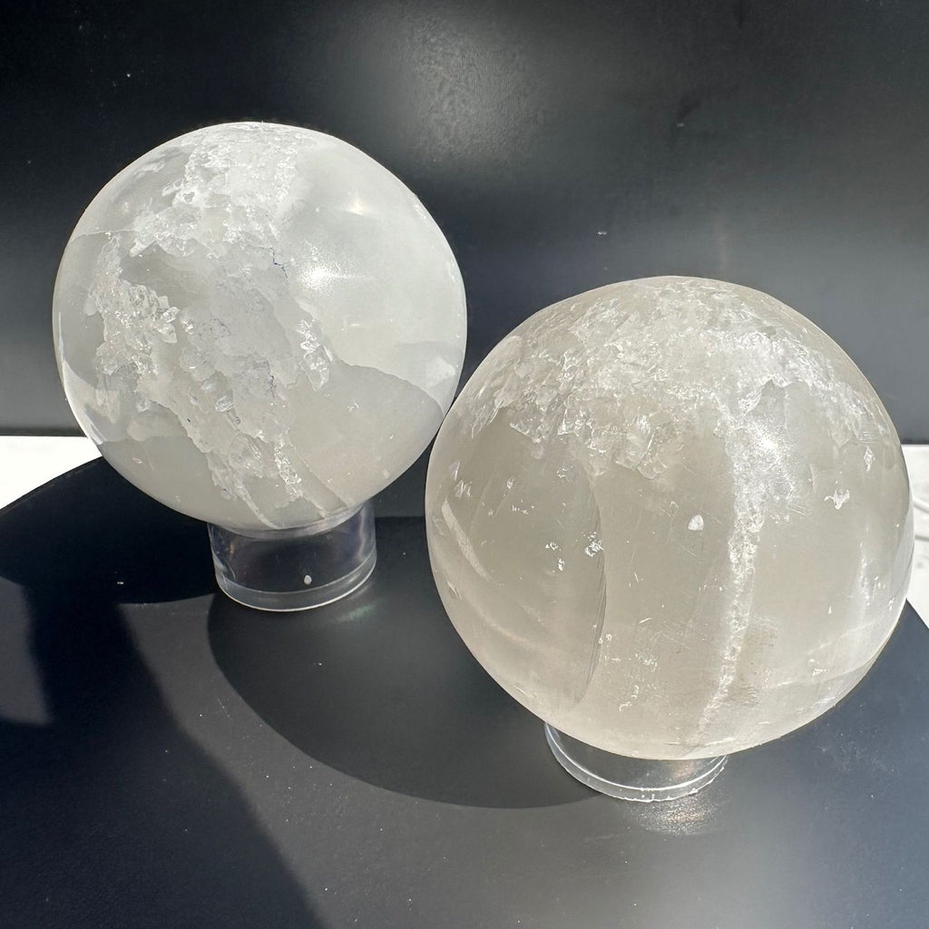 Pair of Selenite Spheres on a crystal display