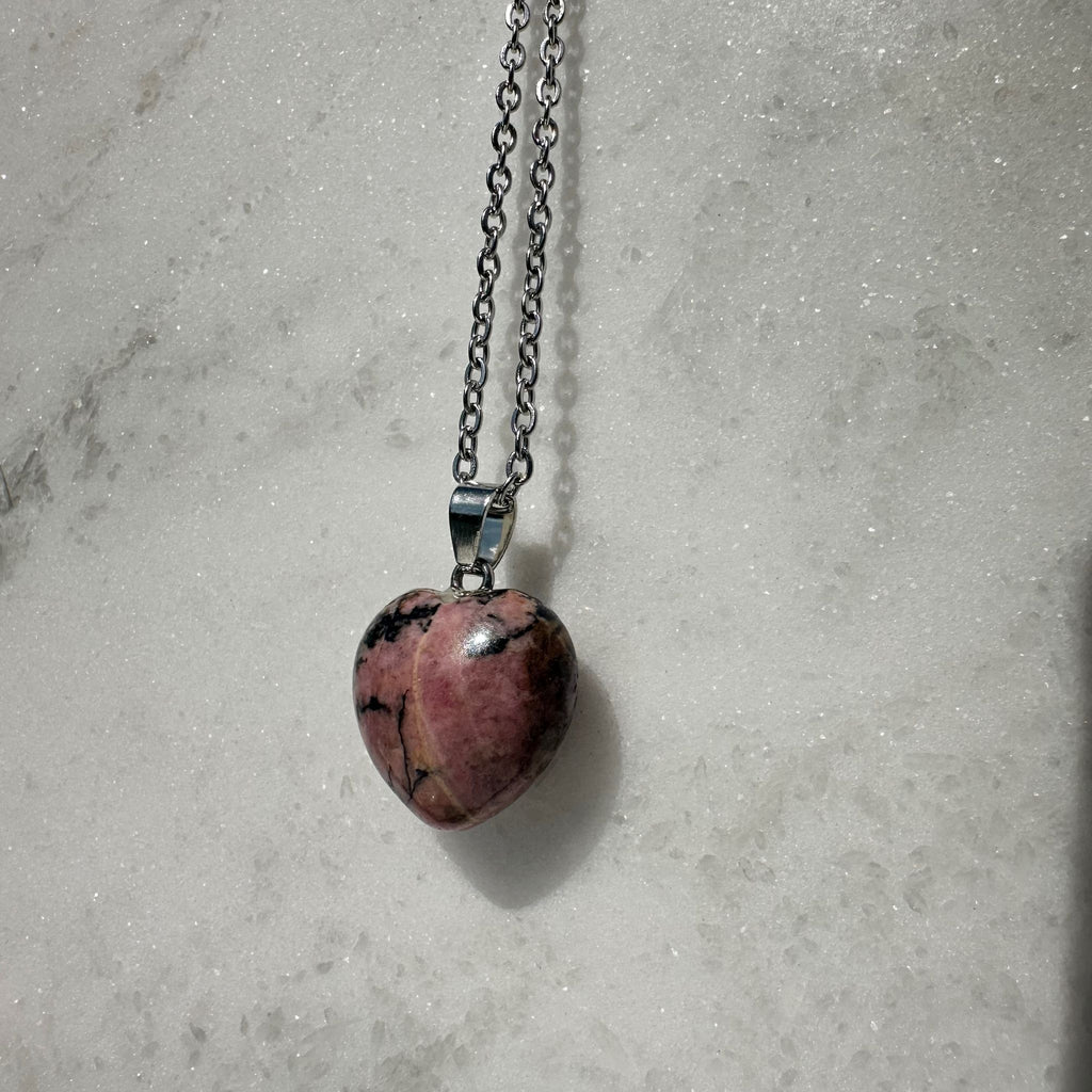 Side angle view of Rhodonite Crystal Carving Pendant