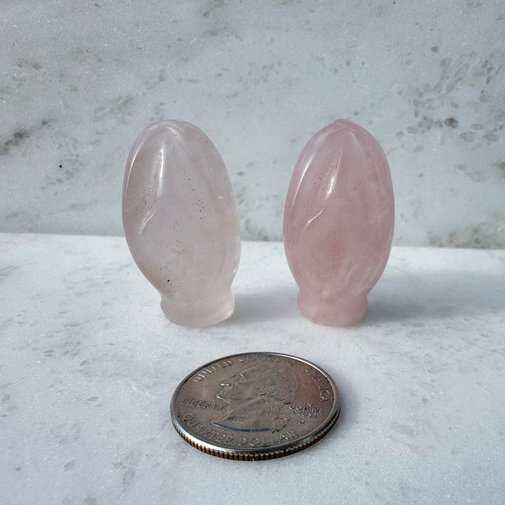 Rose Quartz crystal vulva with quarter for size reference