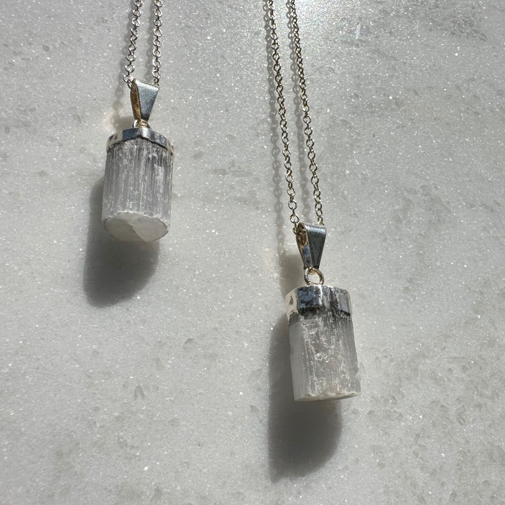 Selenite Barrel shaped pendants hanging on silver plated chain