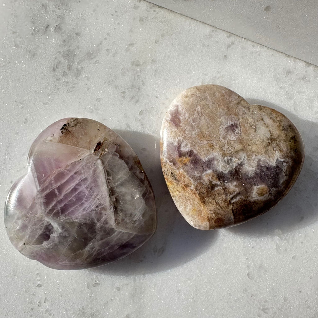 Amethyst heart crystal carvings that are a variation in size and color