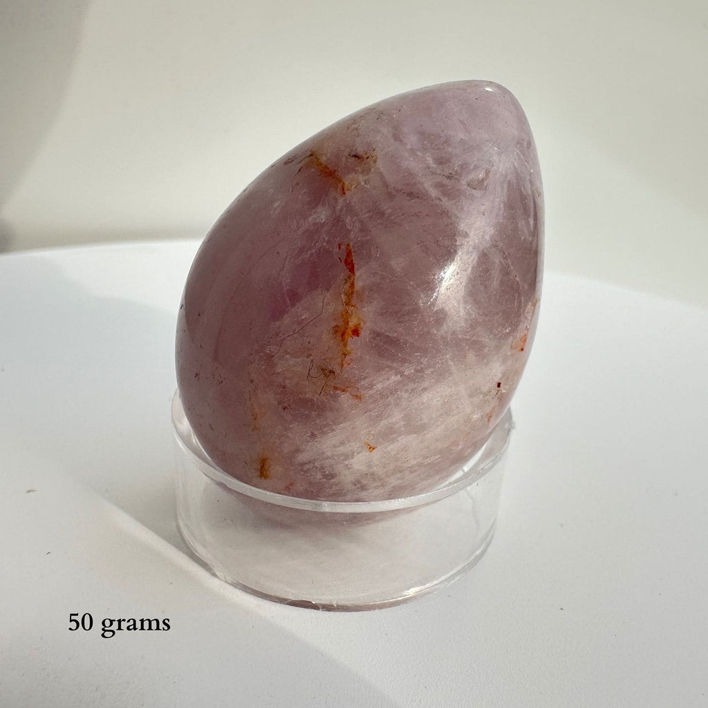 Amethyst Brazilian Crystal Egg Carving on display for closer viewing