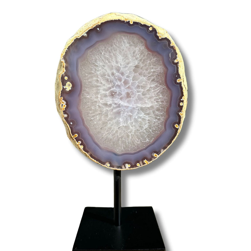Back view of purple banded agate slice with clear quartz center from Brazil, on a stand