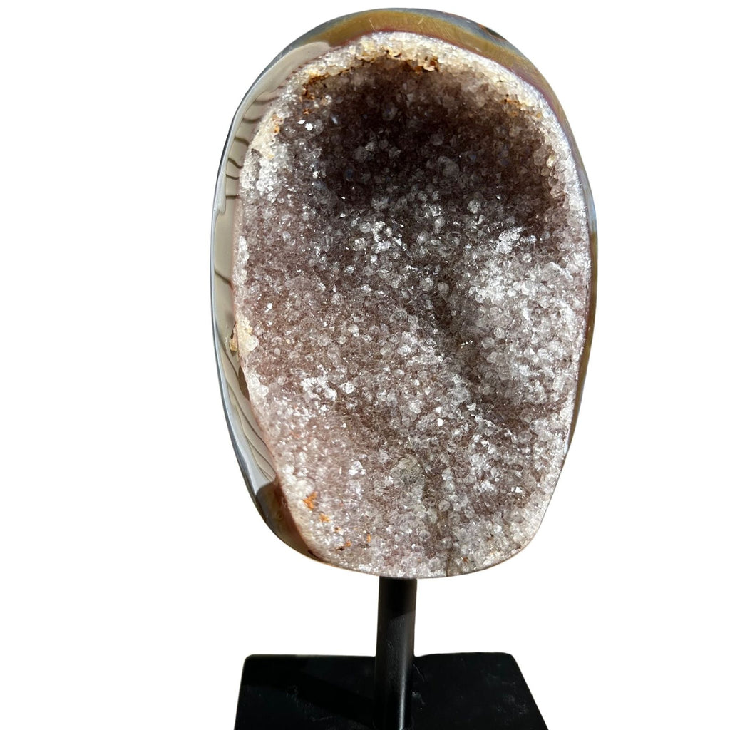 Banded agate on a stand with clear quartz inclusions
