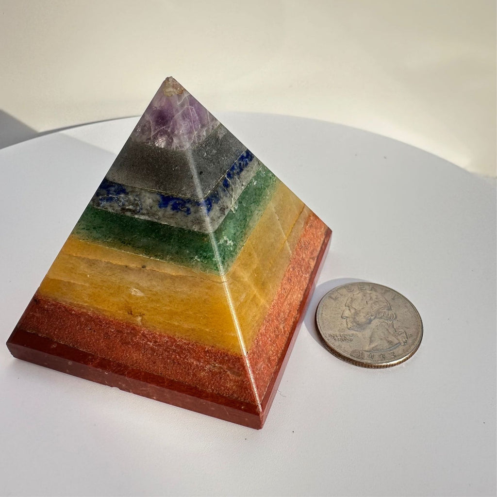 Chakra crystal pyramid with quarter for size reference