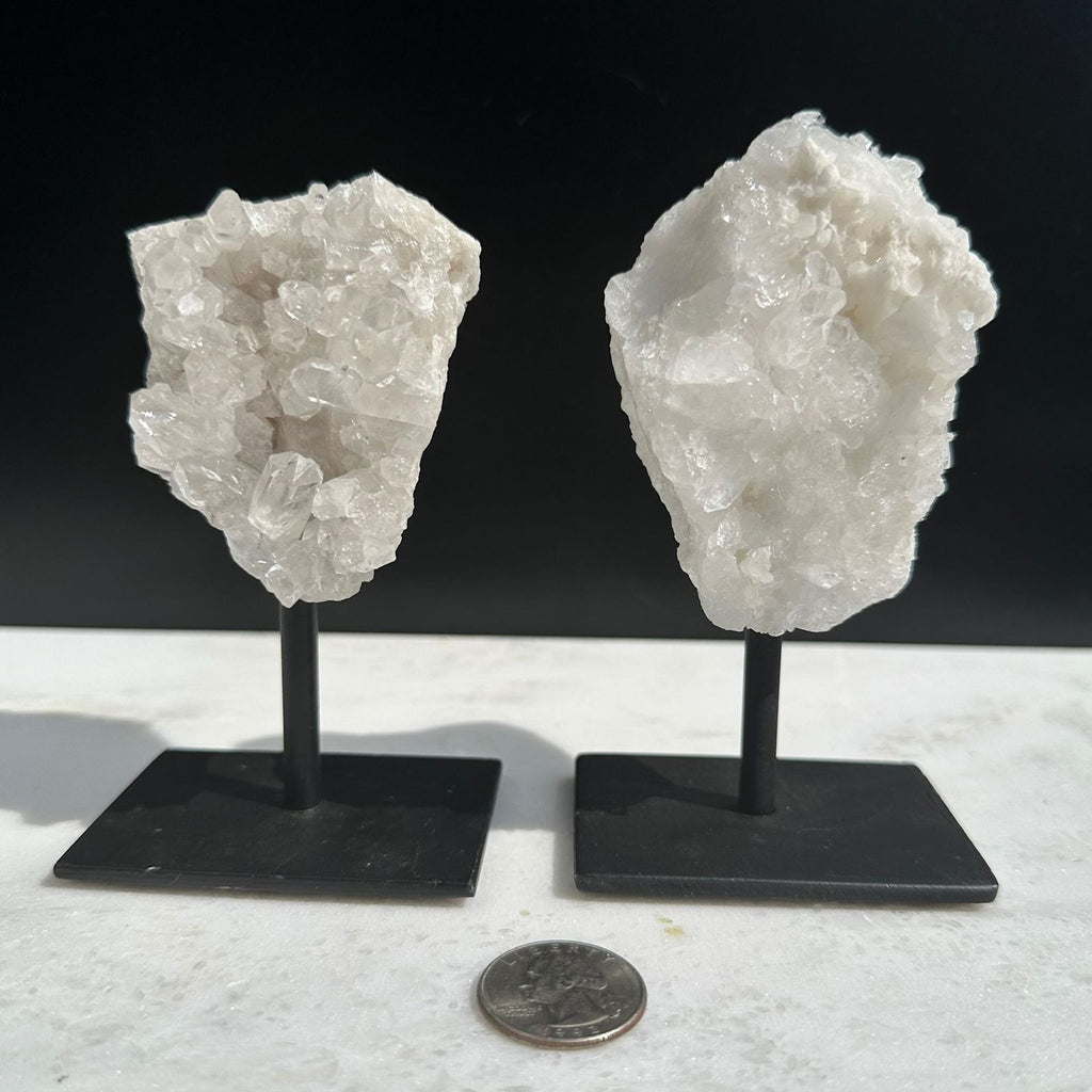 2 clear quartz crystals on a stand for home decor pieces
