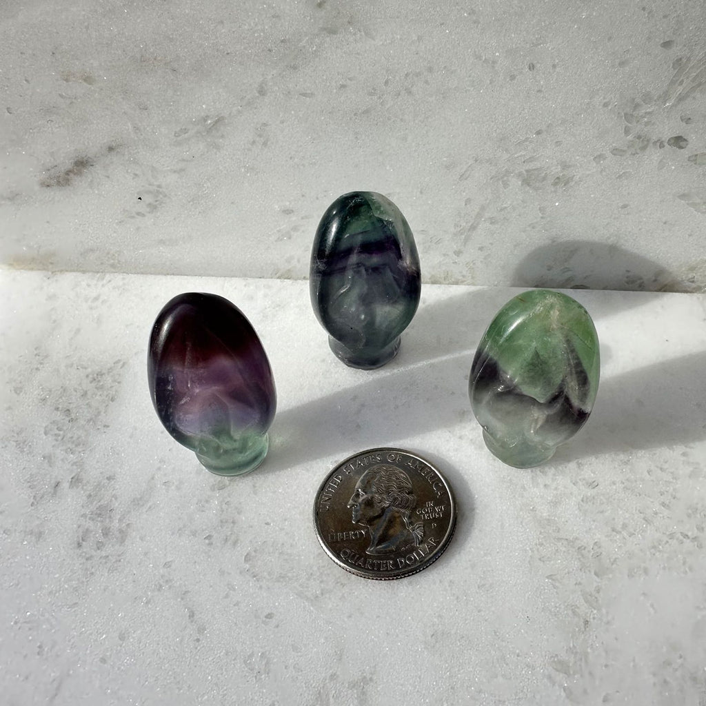 Rainbow Fluorite crystal Portal to Paradise, vulva carvings, next to a quarter for size reference