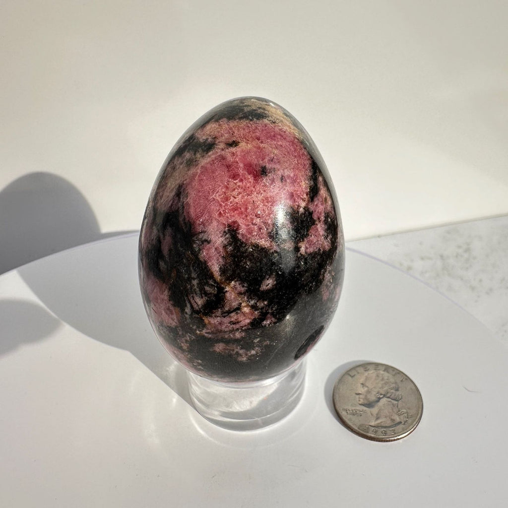 Rhodonite Crystal Egg Carving with quarter for size reference