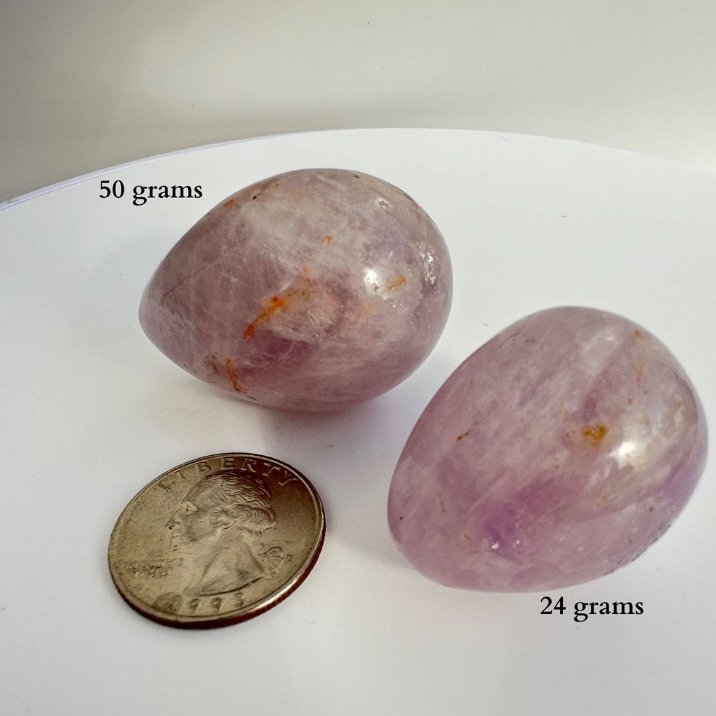 Amethyst Egg crystal carving from Brazil, next to quarter for size reference