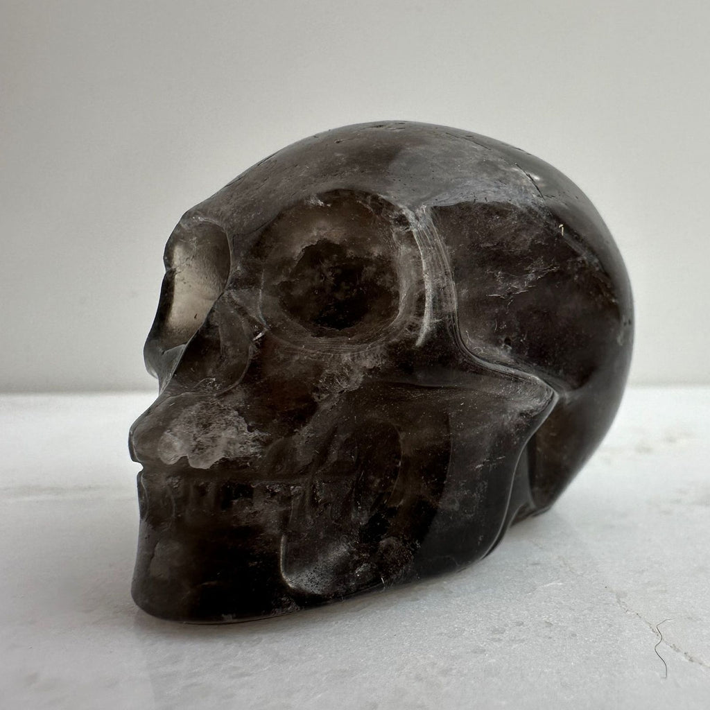 Smoky Quartz Crystal Carving from Brazil, skull carving side profile view