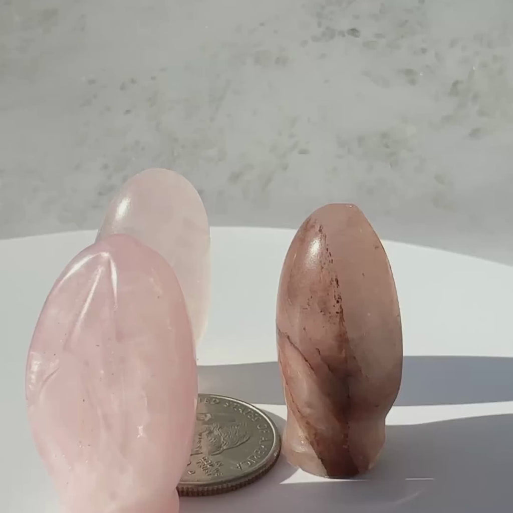 Rose Quartz Crystal vulva Portal to Paradise carvings on a rotating display