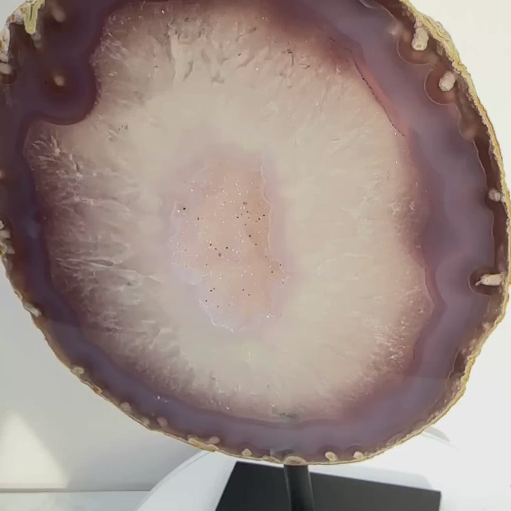 Banded Purple Agate crystal slice on a stand, with raw edges