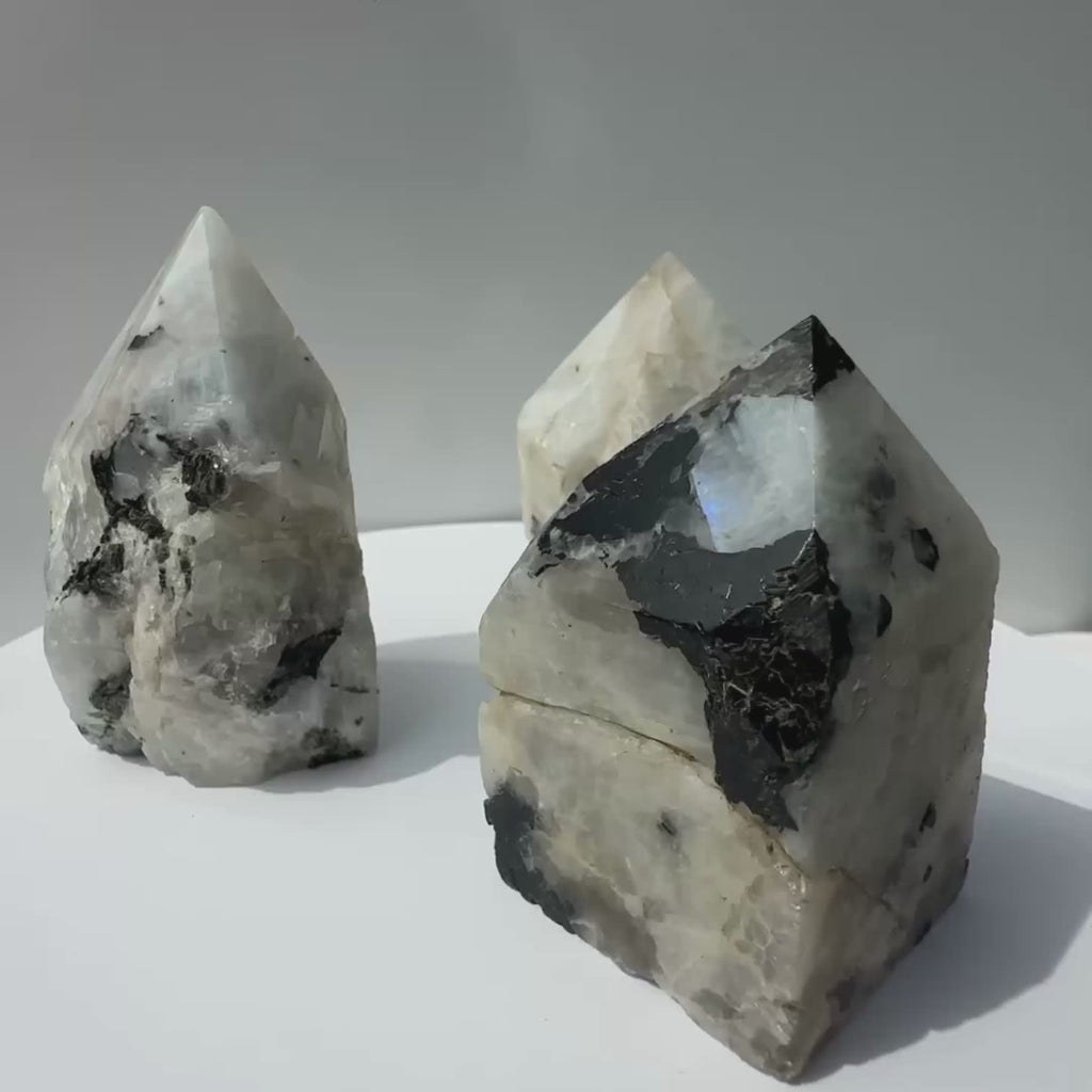 Rainbow Moonstone Crystal Points, rotating on a stand