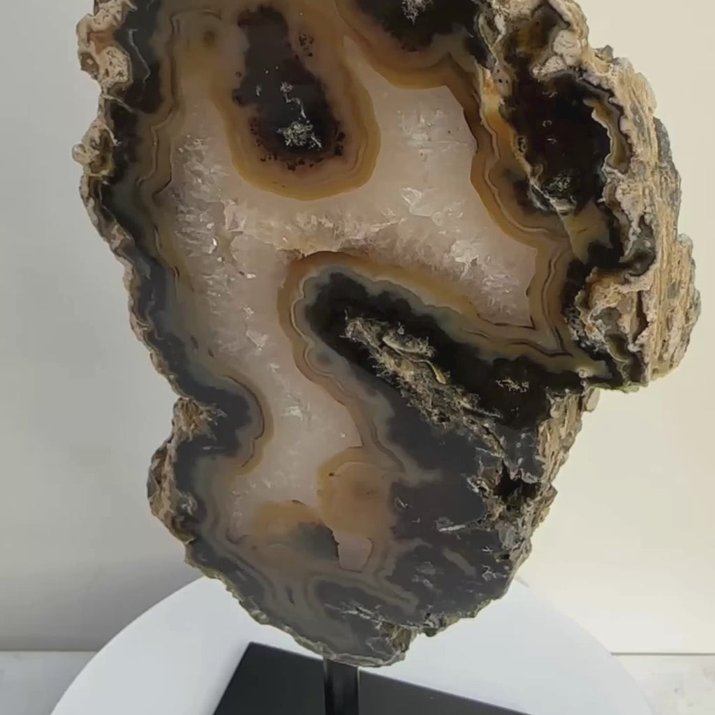 Banded agate, Brazilian crystal, on a rotating stand for display