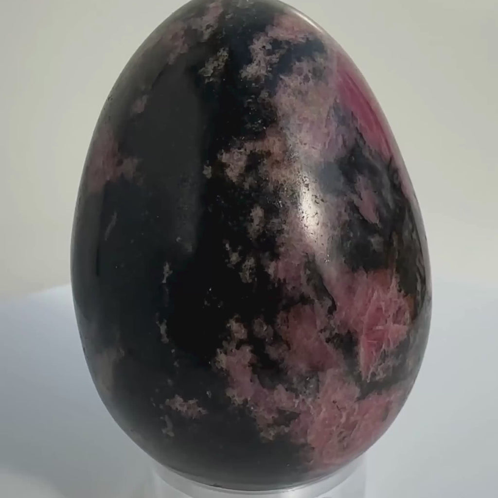 Egg carving of Rhodonite crystal, on rotating display