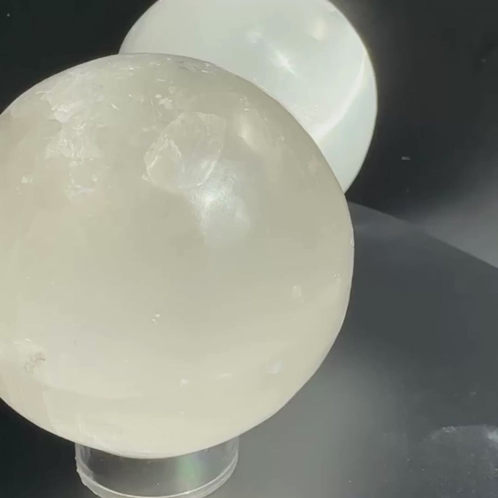 Satin Spar (Selenite) crystal spheres on rotating display for closer view