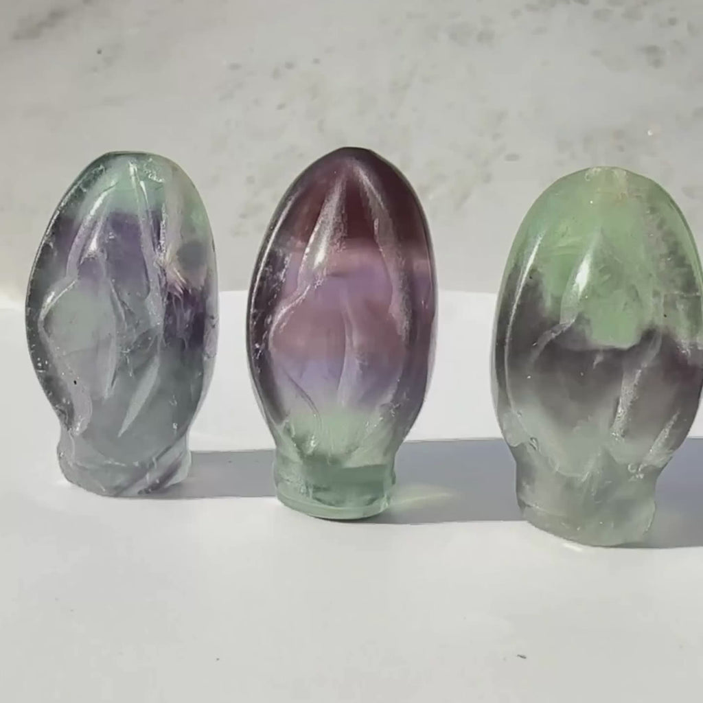 Rainbow Fluorite crystal Portals to Paradise, crystal vulvas, on a rotating display