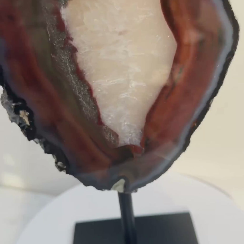 rotating view of banded agate on a stand, agate slice from Brazil, perfect for crystal home decor piece