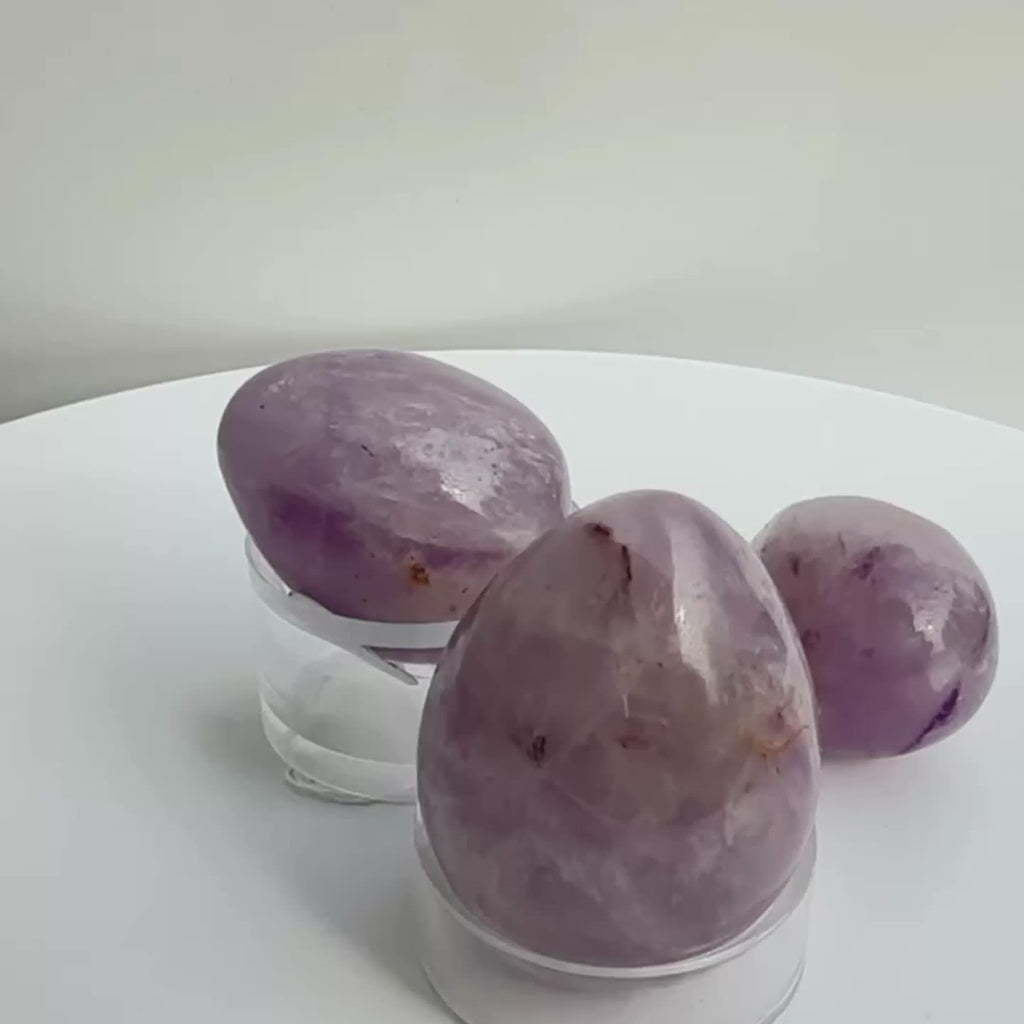 Crystal Amethyst egg carving, on rotating display for viewing of crystals