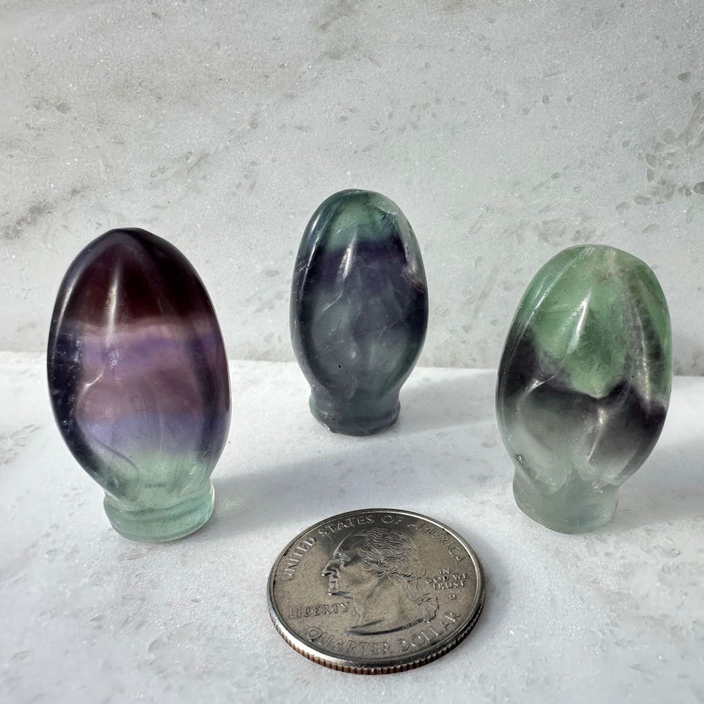 Crystal vulva carvings made out of Rainbow Fluorite and called Portals to paradise