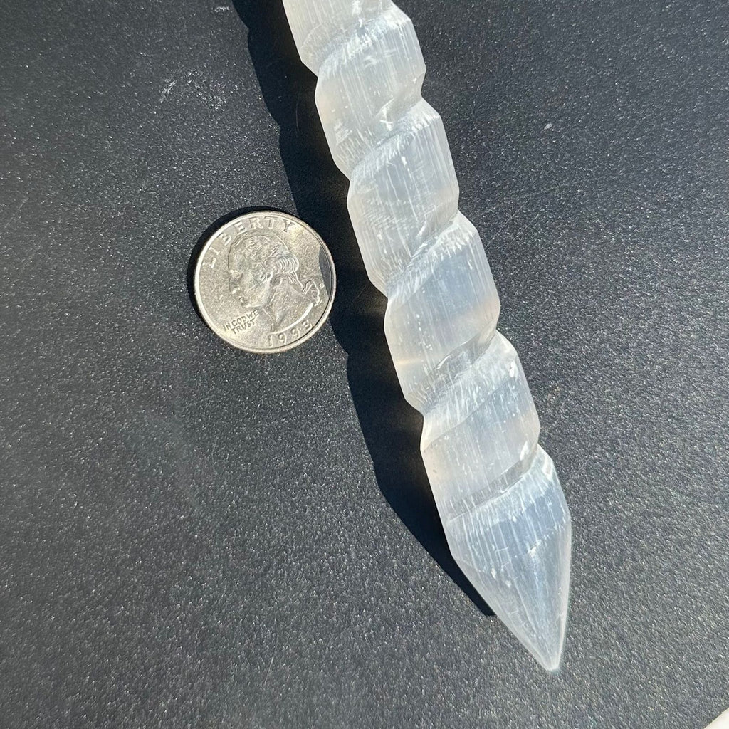 Spiral Selenite Satin Spar Wand next to quarter for Size reference