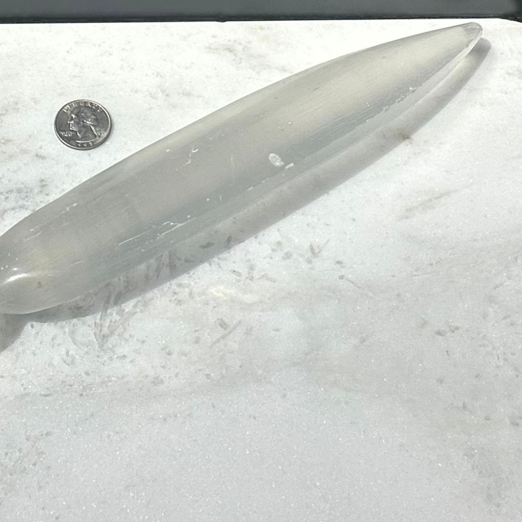 Selenite crystal sword next to quarter 