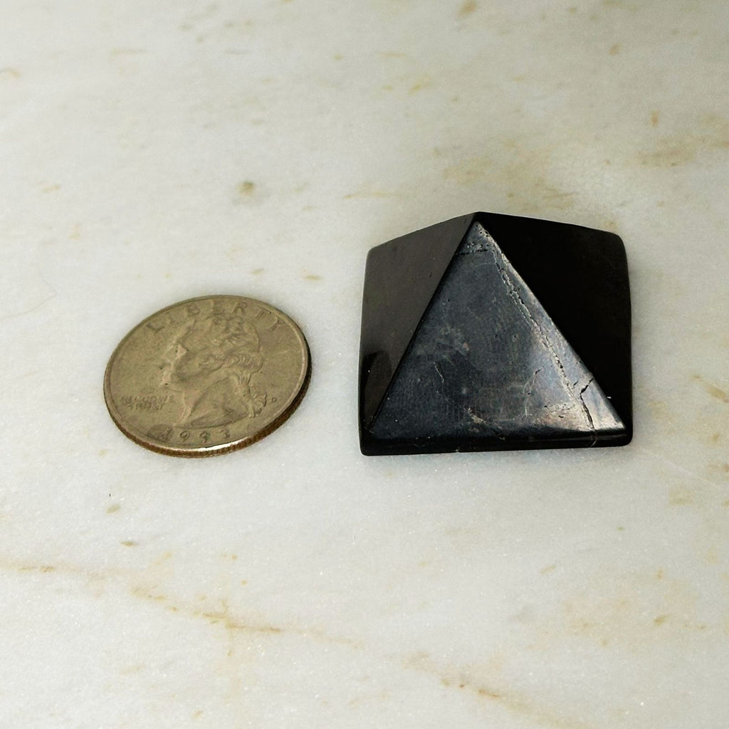 shungite pyramid with quarter for size reference